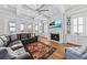 Cozy living room showcases tray ceilings, a fireplace, built-ins, and sliding doors to the outside at 1962 Bellona St, Charleston, SC 29492