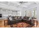Open concept living area flowing into a kitchen with modern cabinetry and a large leather sofa at 1962 Bellona St, Charleston, SC 29492