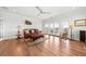 Bright living room boasts hardwood floors, comfortable seating, and access to an outdoor balcony at 1962 Bellona St, Charleston, SC 29492