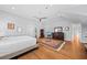 Bright main bedroom boasts hardwood floors, neutral walls, ceiling fan, and elegant decor at 1962 Bellona St, Charleston, SC 29492