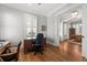 Bright office space showcasing hardwood floors and a doorway to the dining room and living area at 1962 Bellona St, Charleston, SC 29492