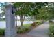 A street view featuring a pond, walking path, decorative lamp post and landscaping at 1962 Bellona St, Charleston, SC 29492