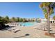 Large outdoor pool with lounge chairs, tables and palm trees on a sunny day at 1962 Bellona St, Charleston, SC 29492