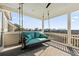 Inviting porch with swing offers a serene spot with lovely neighborhood views at 1962 Bellona St, Charleston, SC 29492