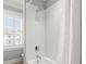 Shower with tile and shower curtain and window with view of surrounding neighborhood at 1962 Bellona St, Charleston, SC 29492