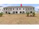 Backyard view of the townhome with grassy area and patio at 205 Cozy Brook Ct, Summerville, SC 29486