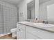 Bathroom showcasing a double sink vanity with a striped shower curtain and a modern toilet at 205 Cozy Brook Ct, Summerville, SC 29486