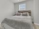 A bedroom showcases a cozy queen-size bed with a wooden headboard and a plush, textured blanket at 205 Cozy Brook Ct, Summerville, SC 29486