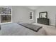 Bright bedroom with natural light, a queen-sized bed, and a wooden dresser by the window at 205 Cozy Brook Ct, Summerville, SC 29486
