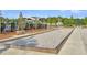 A bocce ball court, perfect for outdoor games and socializing, surrounded by lush greenery at 205 Cozy Brook Ct, Summerville, SC 29486