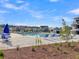 Community pool with seating and water slide featuring serene views of the neighborhood at 205 Cozy Brook Ct, Summerville, SC 29486