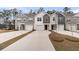 Charming townhomes featuring varied siding colors, attached garages, and concrete driveways lined by well manicured lawns at 205 Cozy Brook Ct, Summerville, SC 29486