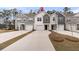 Charming townhomes featuring varied siding colors, attached garages, and concrete driveways lined by well manicured lawns at 205 Cozy Brook Ct, Summerville, SC 29486