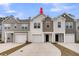 Charming townhomes featuring varied siding colors and attached garages, complemented by concrete driveways and blue skies at 205 Cozy Brook Ct, Summerville, SC 29486