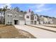 A row of inviting townhomes with varied siding colors, each featuring attached garages and concrete driveways at 205 Cozy Brook Ct, Summerville, SC 29486