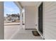 Inviting front porch with a dark-colored door, white siding, and view of a well-maintained street at 205 Cozy Brook Ct, Summerville, SC 29486