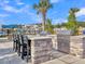Outdoor grilling station with stone countertops and seating, ideal for barbecues and entertaining guests at 205 Cozy Brook Ct, Summerville, SC 29486