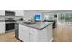 Stylish kitchen featuring an island with sink and seating, open to the living area with sliding glass doors at 205 Cozy Brook Ct, Summerville, SC 29486