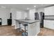 Modern kitchen with a large island, seating, stainless steel appliances, and ample white cabinetry at 205 Cozy Brook Ct, Summerville, SC 29486