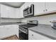 Well-lit kitchen featuring stainless steel appliances, gray countertops, and white cabinets at 205 Cozy Brook Ct, Summerville, SC 29486