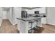 Well-equipped kitchen featuring an island with seating, stainless steel appliances, and white cabinets at 205 Cozy Brook Ct, Summerville, SC 29486