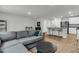 Inviting open living space with a comfortable grey sectional and barstool seating at the kitchen island at 205 Cozy Brook Ct, Summerville, SC 29486
