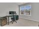 This office features a desk, chair, shelves, and a large window showing the neighborhood at 205 Cozy Brook Ct, Summerville, SC 29486