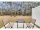 Outdoor patio featuring a table with two chairs, with view of the wooded backyard at 205 Cozy Brook Ct, Summerville, SC 29486