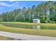Scenic pond with a small white shelter near a treeline at 205 Cozy Brook Ct, Summerville, SC 29486