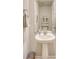 Well-lit half bathroom featuring a pedestal sink, large mirror, and tasteful decor at 215 Camellia Bloom Dr, Moncks Corner, SC 29461