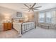Bedroom with a ceiling fan, natural light, and coordinating nightstands and lamps at 215 Camellia Bloom Dr, Moncks Corner, SC 29461