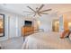 Bright bedroom featuring large ceiling fan, view to ensuite bathroom, and natural light at 215 Camellia Bloom Dr, Moncks Corner, SC 29461