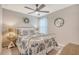Cozy bedroom with decorative wreath, round mirror, ceiling fan, and natural light at 215 Camellia Bloom Dr, Moncks Corner, SC 29461