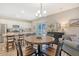Charming dining area with round table, modern lighting, and view to kitchen at 215 Camellia Bloom Dr, Moncks Corner, SC 29461