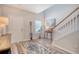 Bright foyer features a staircase, stylish rug, and elegant decor at 215 Camellia Bloom Dr, Moncks Corner, SC 29461
