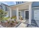 Inviting front porch with seating and decorative plants, perfect for relaxing outdoors at 215 Camellia Bloom Dr, Moncks Corner, SC 29461