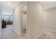 Hallway view to full bathroom and living room with neutral walls and carpet at 215 Camellia Bloom Dr, Moncks Corner, SC 29461