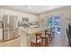 Bright kitchen featuring a large island with seating and sliding door to outside at 215 Camellia Bloom Dr, Moncks Corner, SC 29461