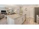 Open concept kitchen featuring a large island, modern appliances, and seamless flow to living space at 215 Camellia Bloom Dr, Moncks Corner, SC 29461