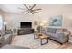 Inviting living room with stylish decor, ceiling fan, and comfortable gray sofas at 215 Camellia Bloom Dr, Moncks Corner, SC 29461