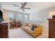 Comfortable living room featuring a ceiling fan, sofa, and natural light from multiple windows at 215 Camellia Bloom Dr, Moncks Corner, SC 29461