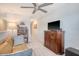 Living room with a comfortable leather sofa, ceiling fan, and a dark wood entertainment center at 215 Camellia Bloom Dr, Moncks Corner, SC 29461