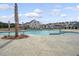 Large community pool surrounded by palm trees offering a refreshing escape and ample space for relaxation at 215 Camellia Bloom Dr, Moncks Corner, SC 29461