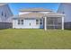 Large backyard featuring a well-maintained lawn and a screened patio offering a serene outdoor space at 215 Shortmarsh St, Summerville, SC 29486