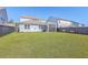 Spacious backyard with green lawn and screened-in porch, providing a private and serene outdoor retreat at 215 Shortmarsh St, Summerville, SC 29486