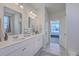 Bright bathroom features double sinks with white cabinets and a view into the main bedroom at 215 Shortmarsh St, Summerville, SC 29486