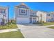 Two-story home with blue siding, a front-facing garage, and manicured landscaping at 215 Shortmarsh St, Summerville, SC 29486
