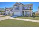 Well-maintained two-story home with blue siding, a garage, and a green lawn at 215 Shortmarsh St, Summerville, SC 29486