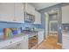 Updated kitchen with stainless steel appliances, granite countertops, and modern white cabinetry at 215 Shortmarsh St, Summerville, SC 29486