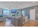 Open concept kitchen with granite island, stainless appliances, and views to the fireplace in living room at 215 Shortmarsh St, Summerville, SC 29486